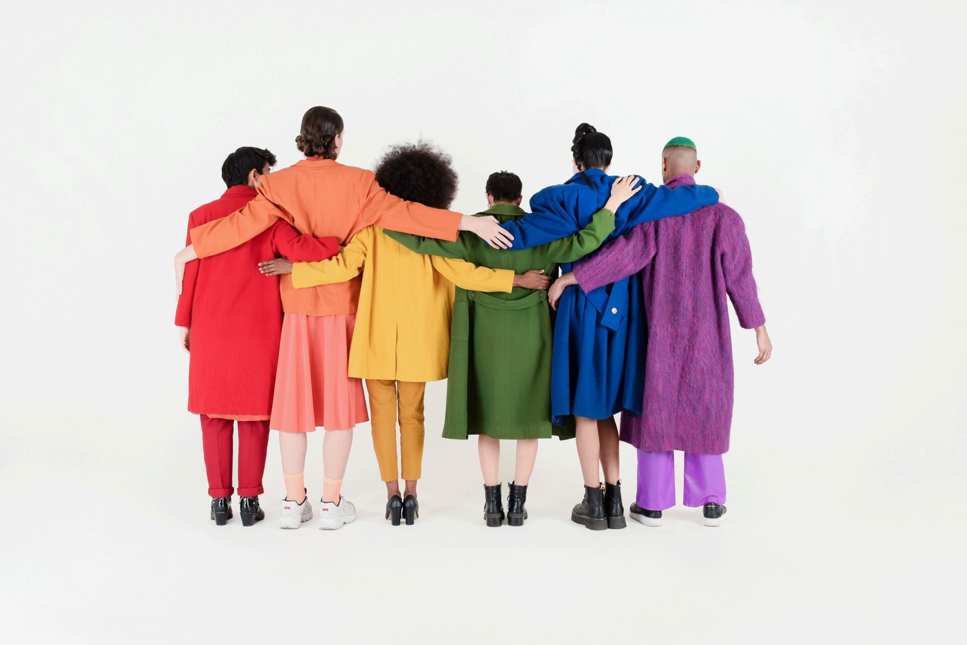 People facing away with arms interlocked.